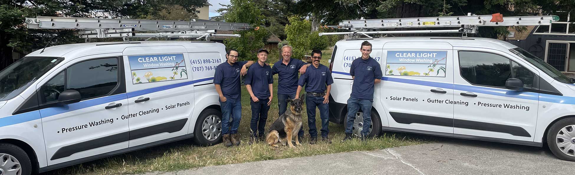 team members with trucks and dog